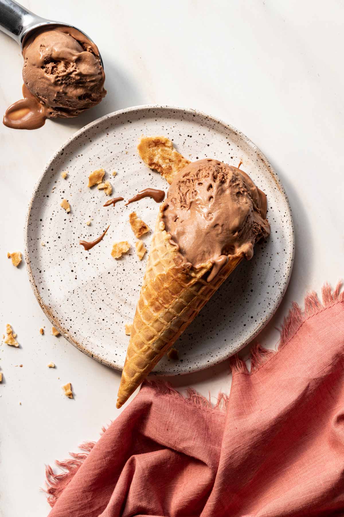 No churn chocolate ice cream in a waffle cone on a plate