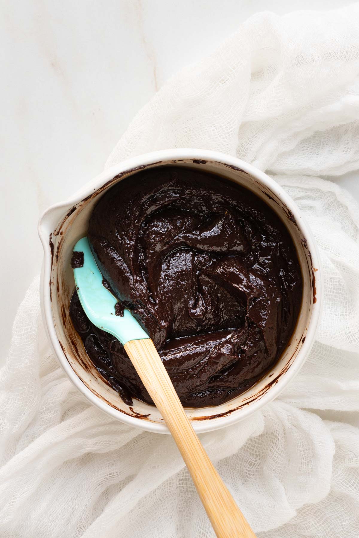 Chocolate sauce in a clay bowl with a spatula