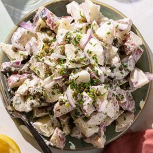 Potato salad with capers on a green plate