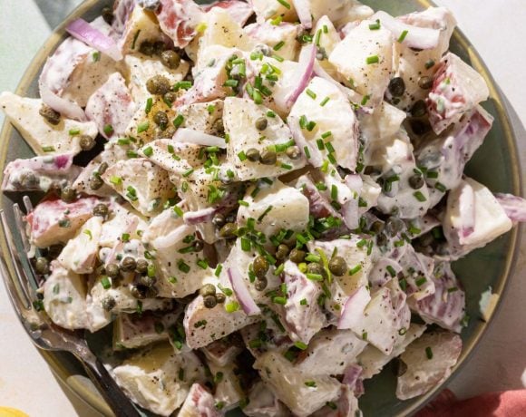 Potato salad with capers on a green plate