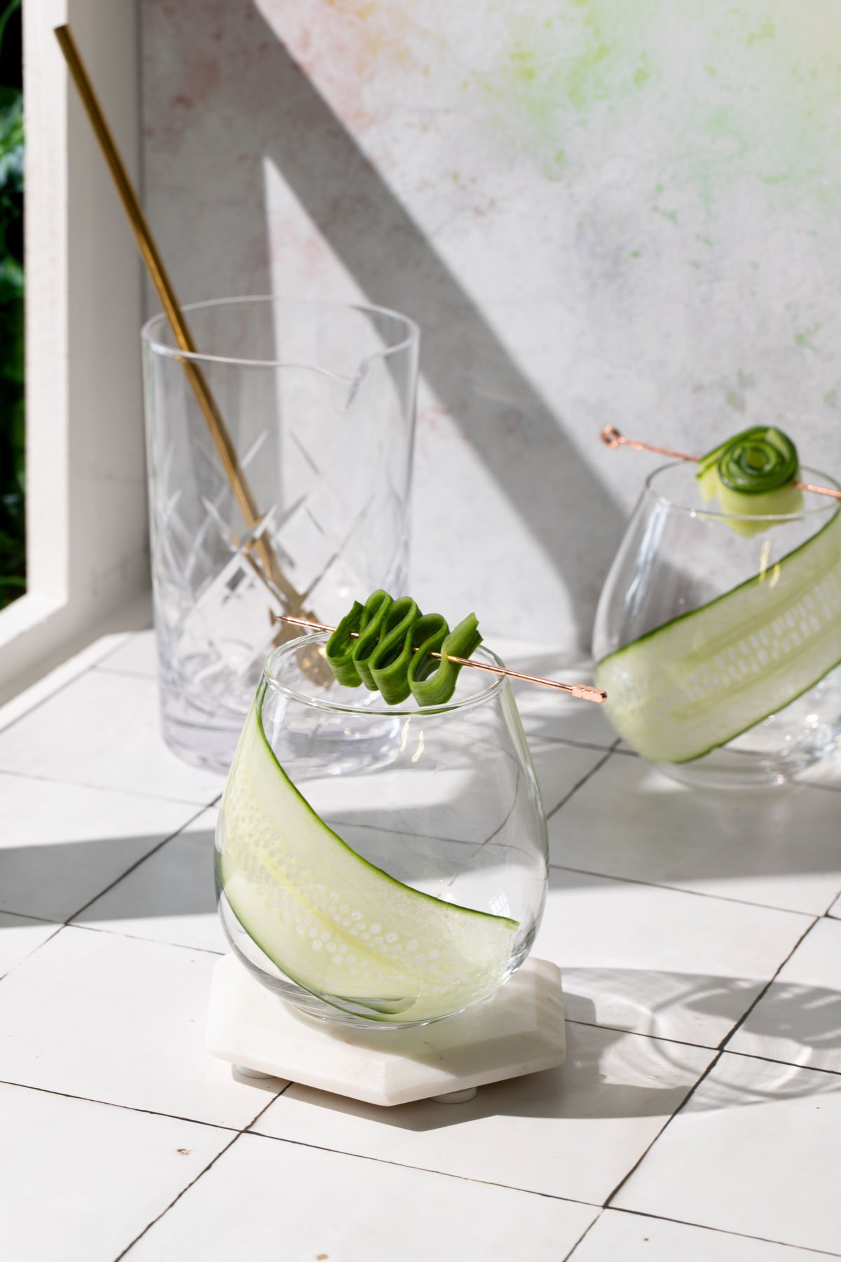 Cucumber slices and cocktail pick in glasses