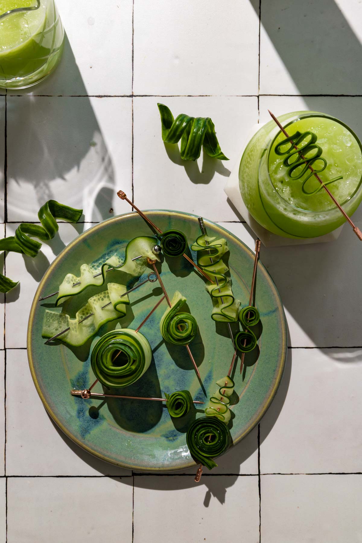 Cucumber slices with cocktail pics on a plate