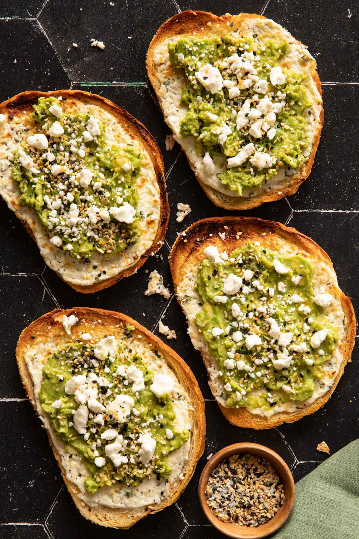 Four Goat Cheese Avocado Toasts with a green napkin