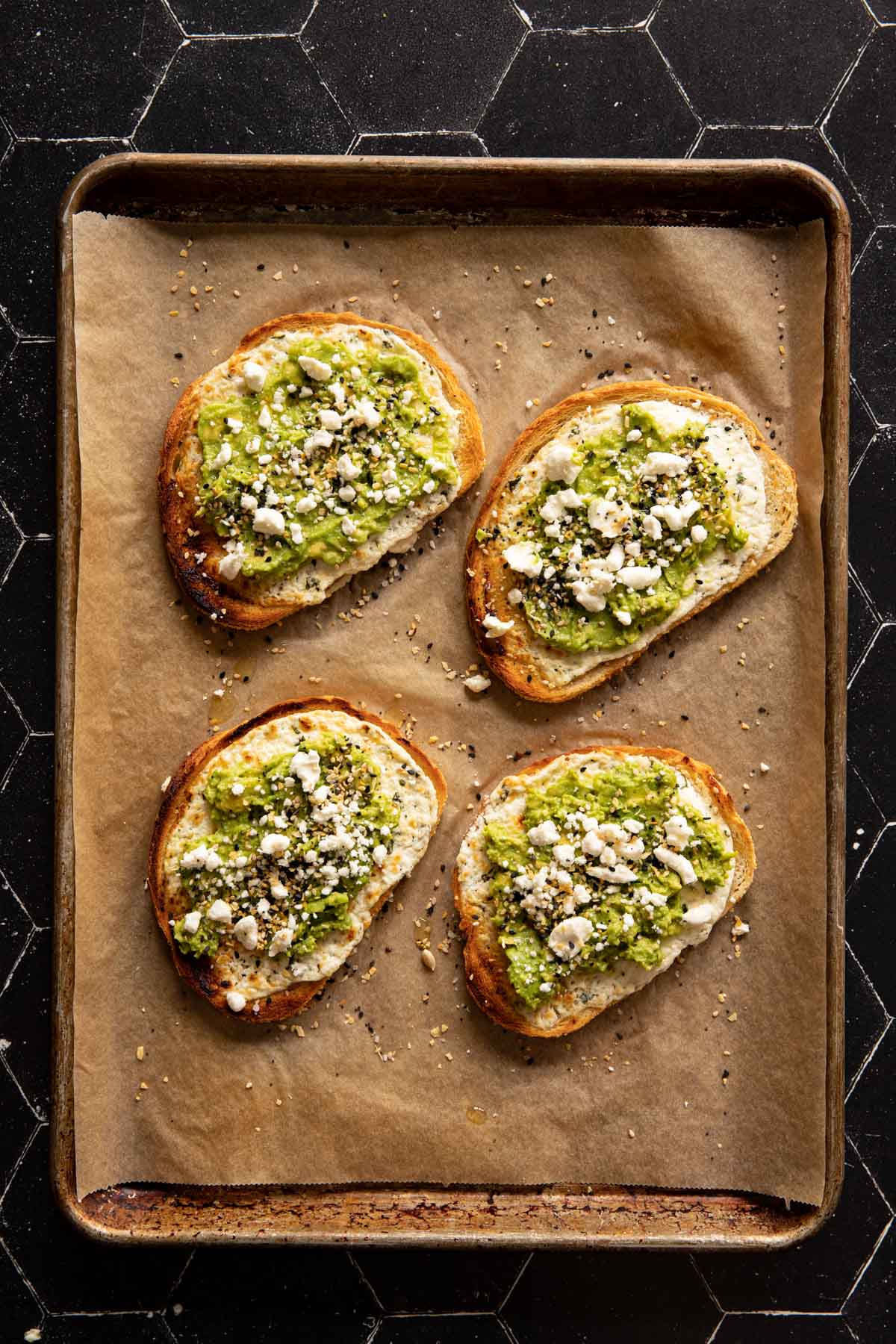 Goat cheese avocado toasts on a sheet pan