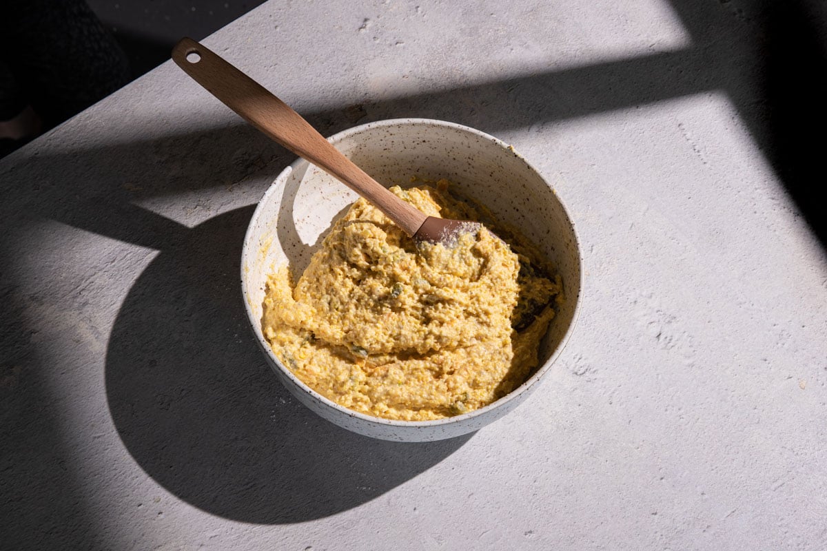 Cornbread batter in a bowl with a spatula