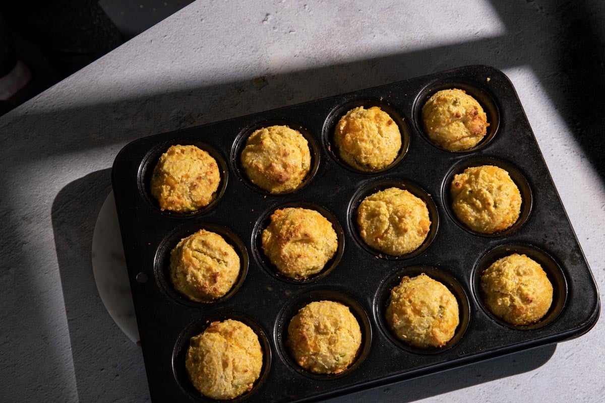 Jalapeno cheddar cornbread muffins baked in a muffin tin