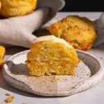 Jalapeno cheddar cornbread muffin with butter on a plate