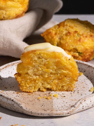 Jalapeno cheddar cornbread muffin with butter on a plate
