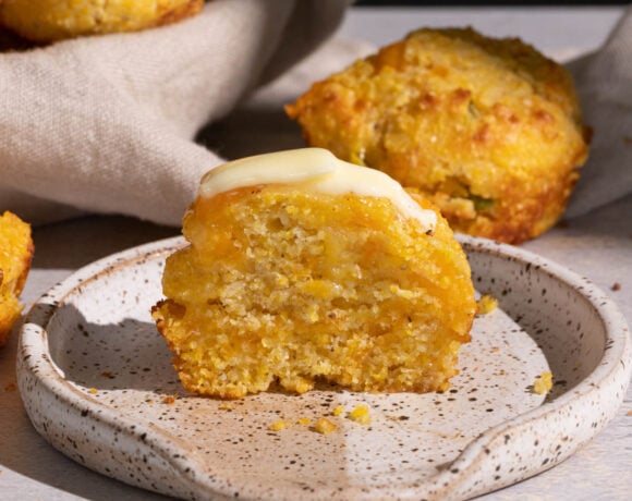 Jalapeno cheddar cornbread muffin with butter on a plate