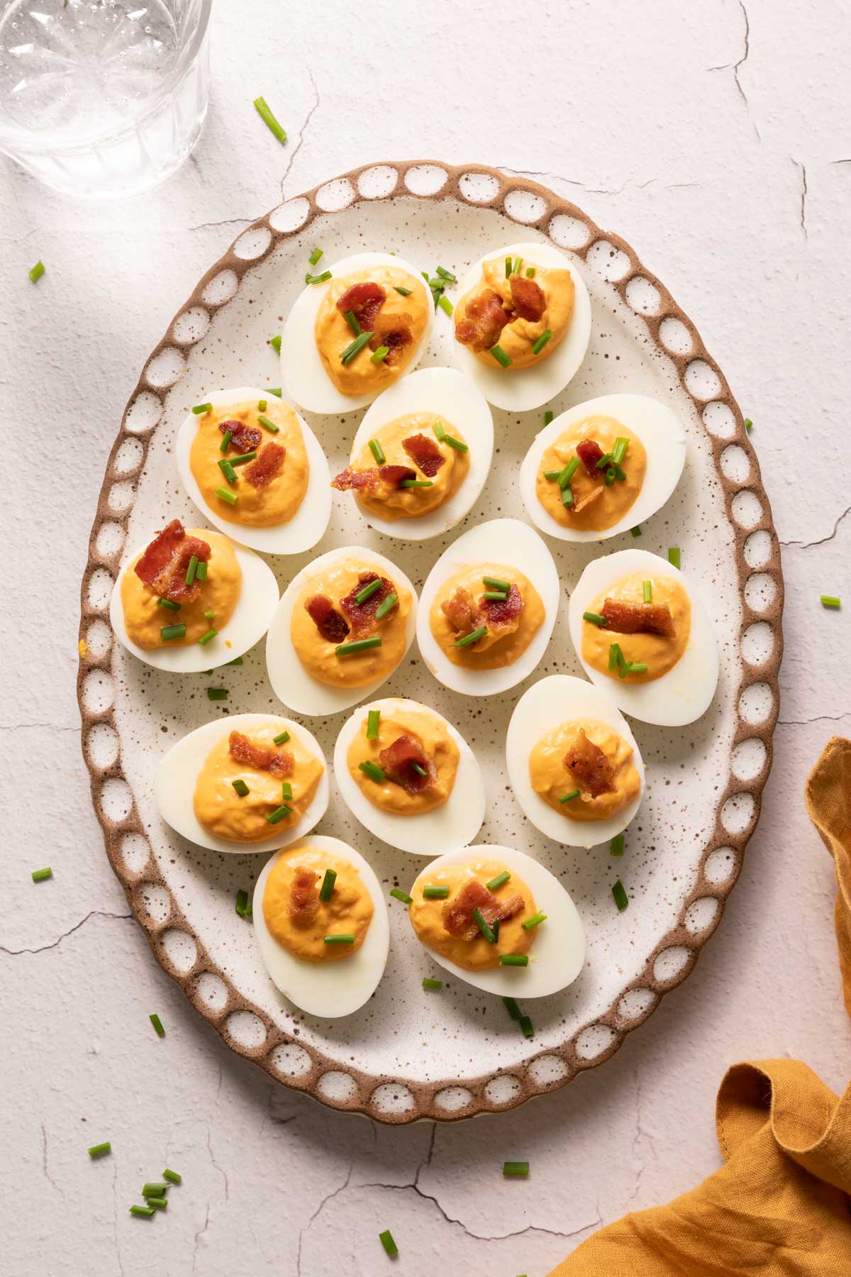 Pimento deviled eggs on an oval plate