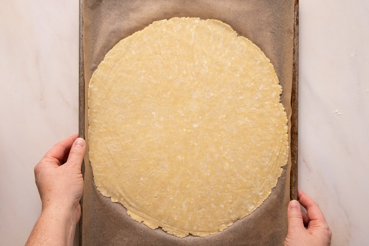 Pie crust on parchment on a sheet pan