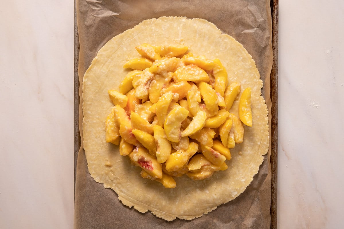 peach filling in the center of an unbaked pie crust