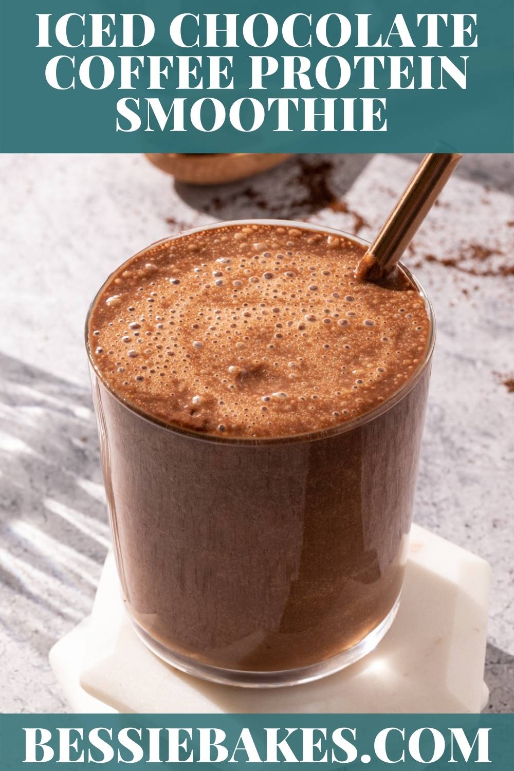 Iced Chocolate Coffee smoothie in a glass with foam on top via @bessiebakes