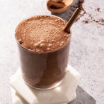 Iced chocolate coffee smoothie in a glass with a metal straw