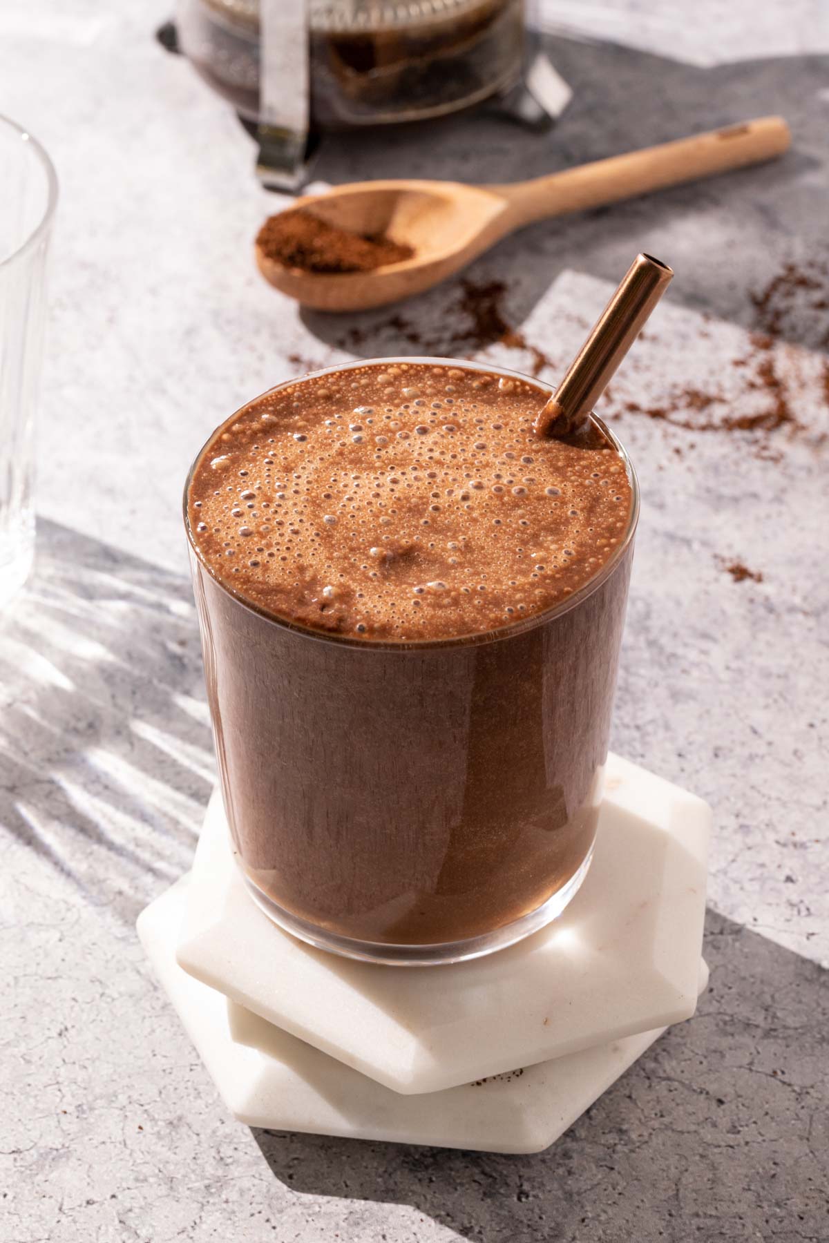 Iced Coffee smoothie in a glass with a straw