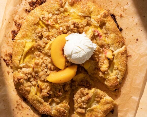 A peach crostata with a scoop of vanilla ice cream on top