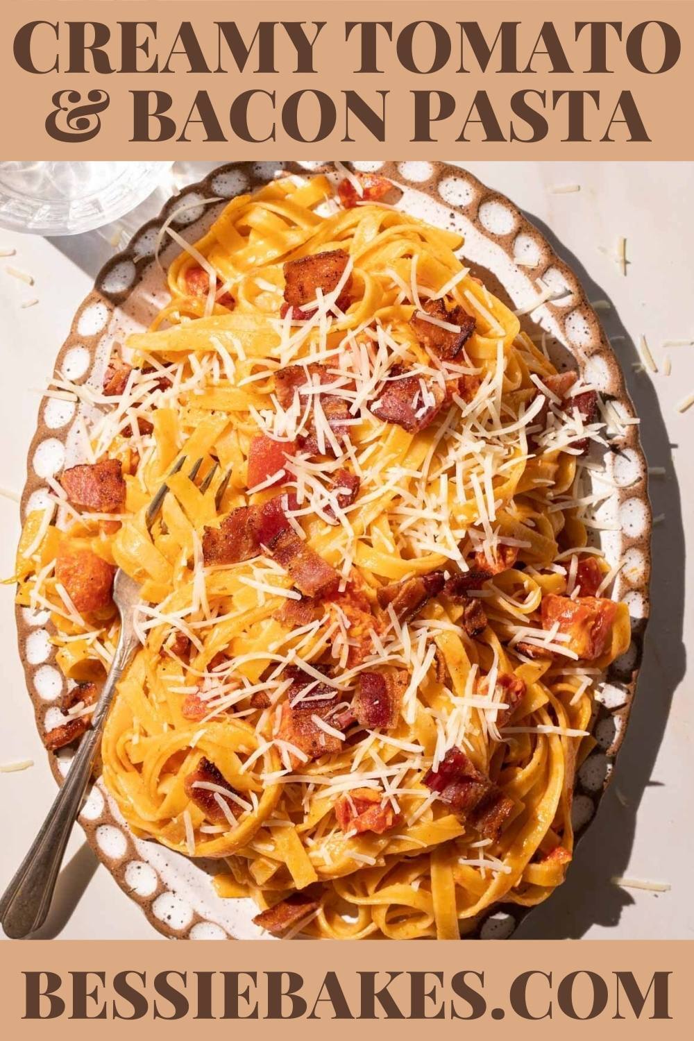 Creamy tomato pasta with bacon and cheese on a plate via @bessiebakes