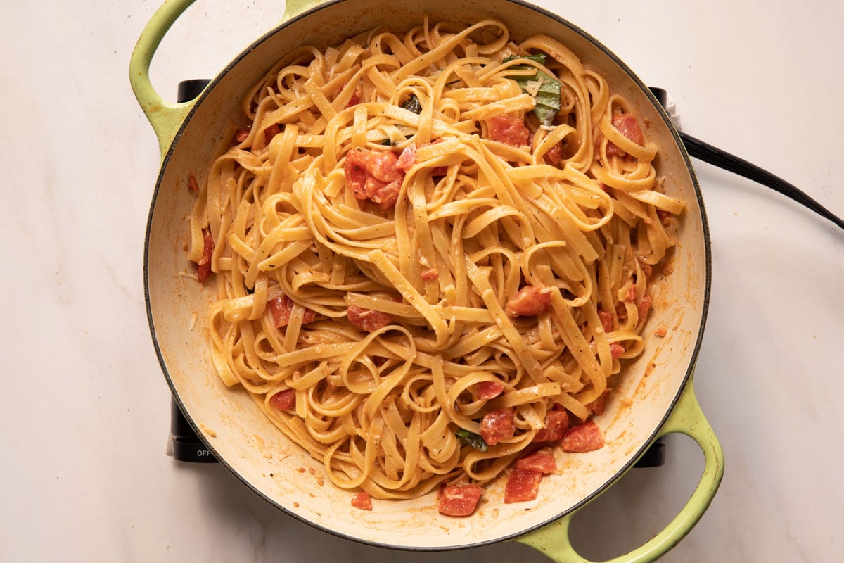 Creamy bacom tomato pasta in a saute pan