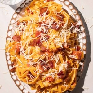 Creamy Tomato bacon pasta on a pottery plate