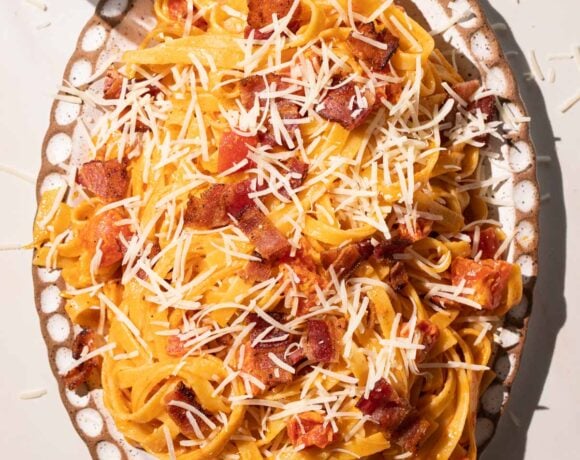 Creamy Tomato bacon pasta on a pottery plate