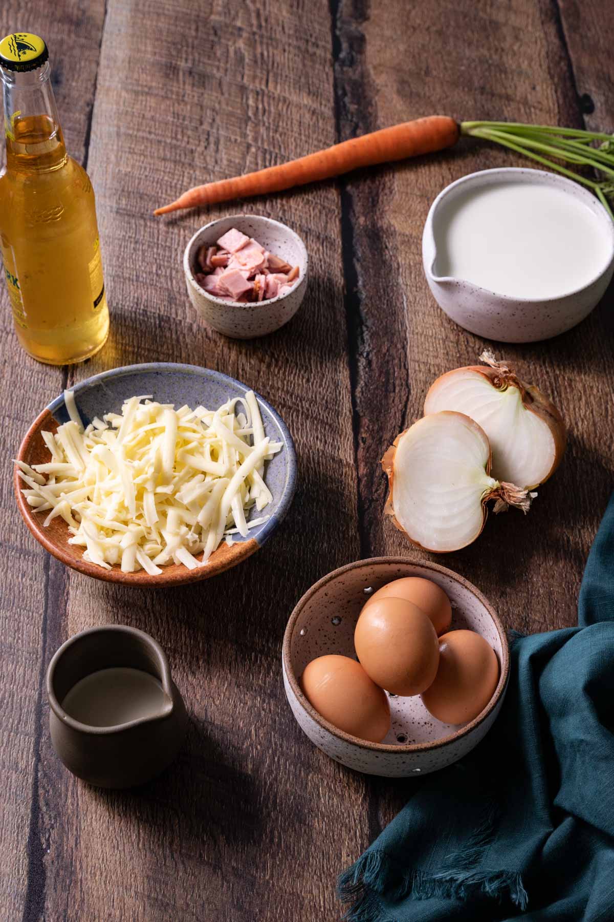 A bowl of eggs, milk, cream, cheese, and beer for a French quiche recipe