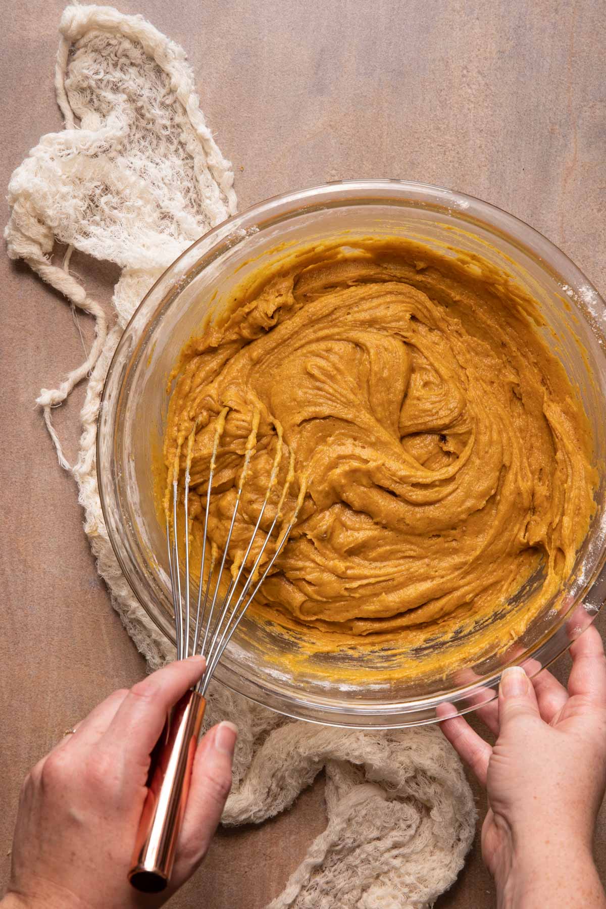 Pumpkin muffin batter being whisked in a bowl