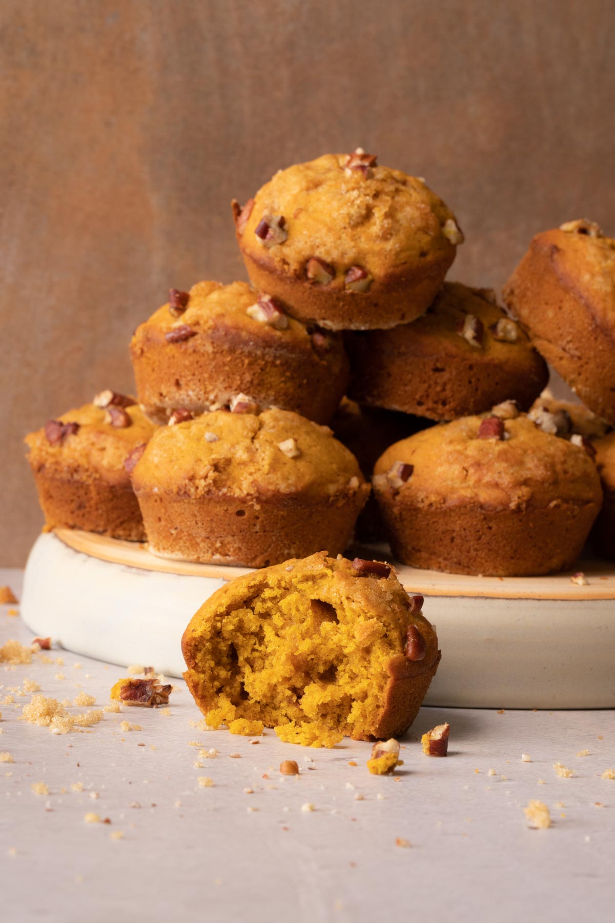 Pumpkin muffins stacked on a plate