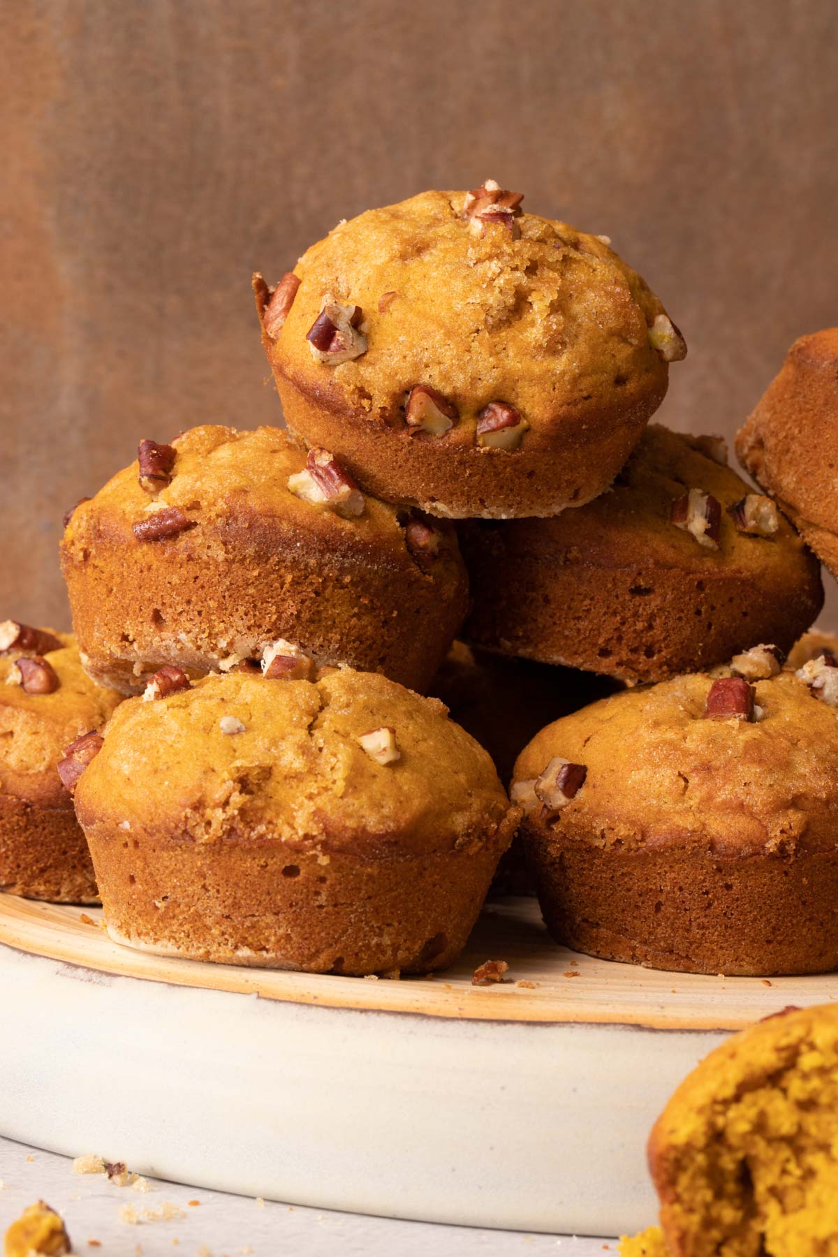 Pumpkin muffins stacked on a pottery plate