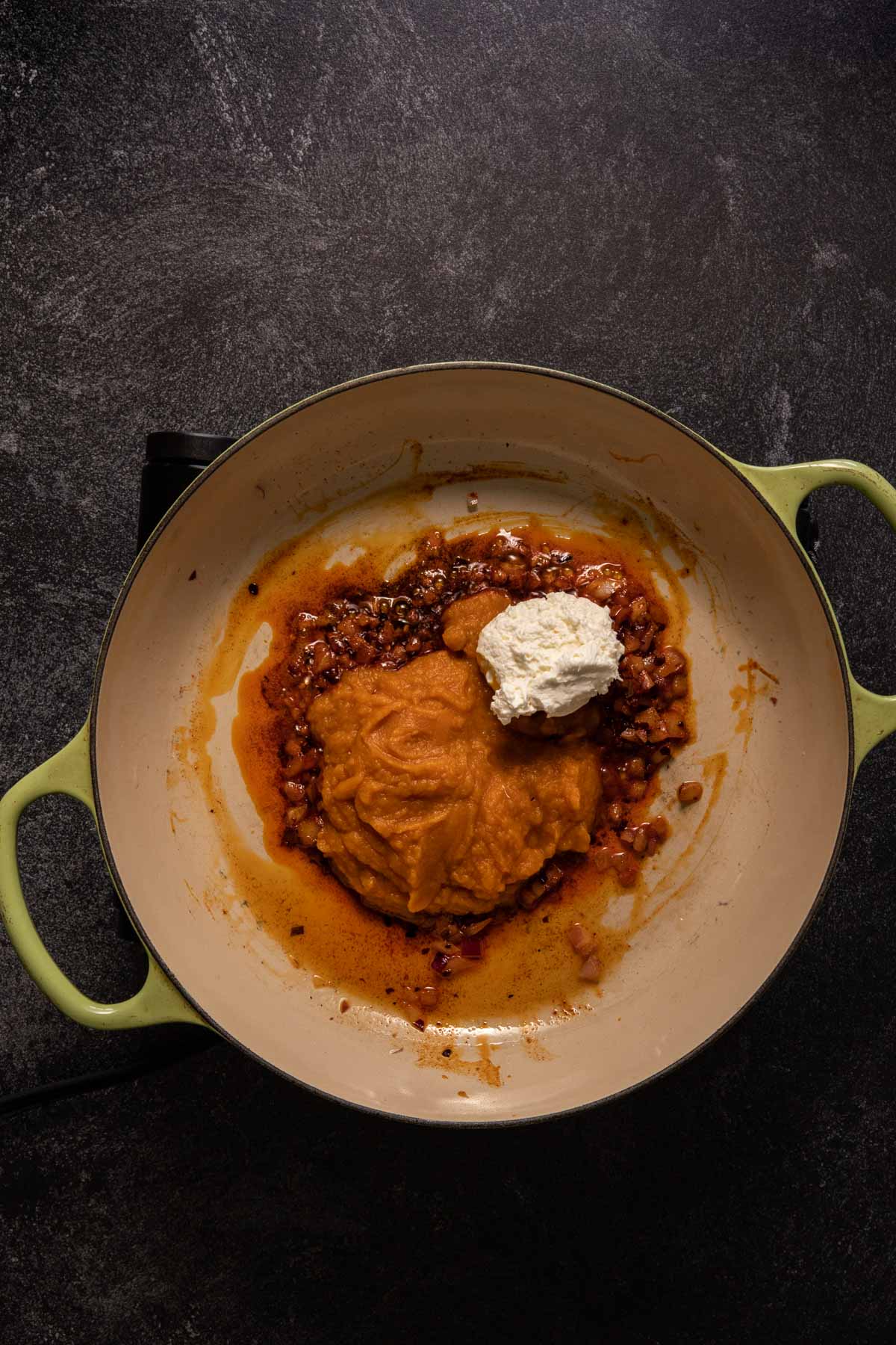 Pumpkin puree and cream cheese in a saute pan