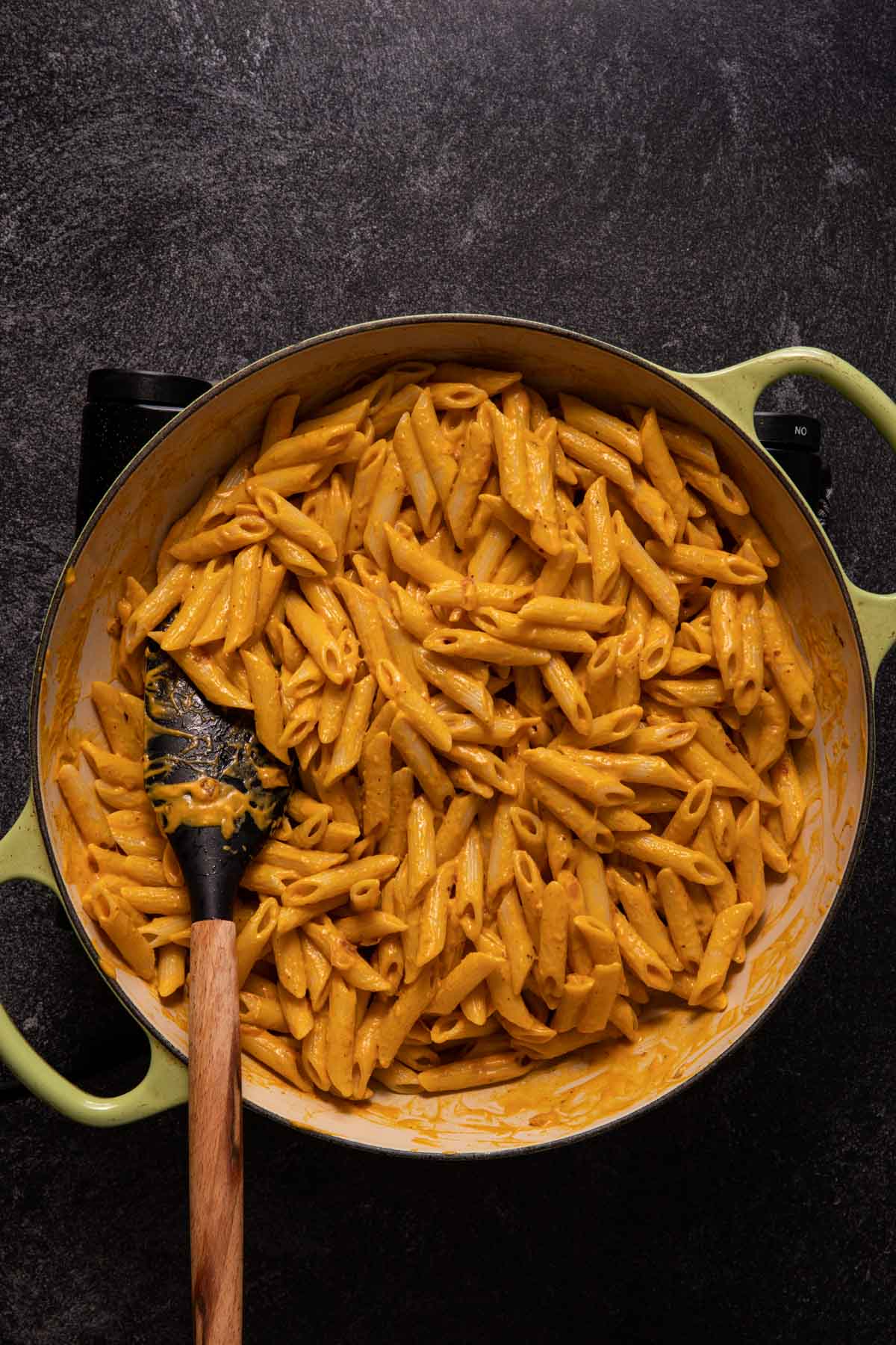 Penne pasta with pumpkin sauce in a pan