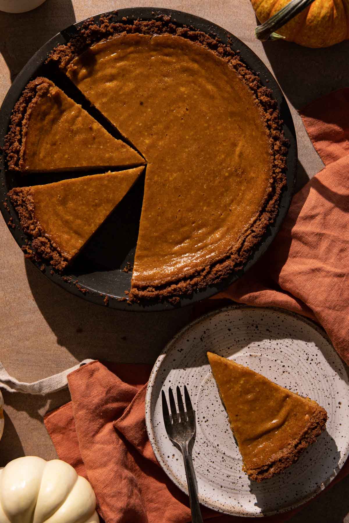 Cream cheese pumpkin pie slices in a pan