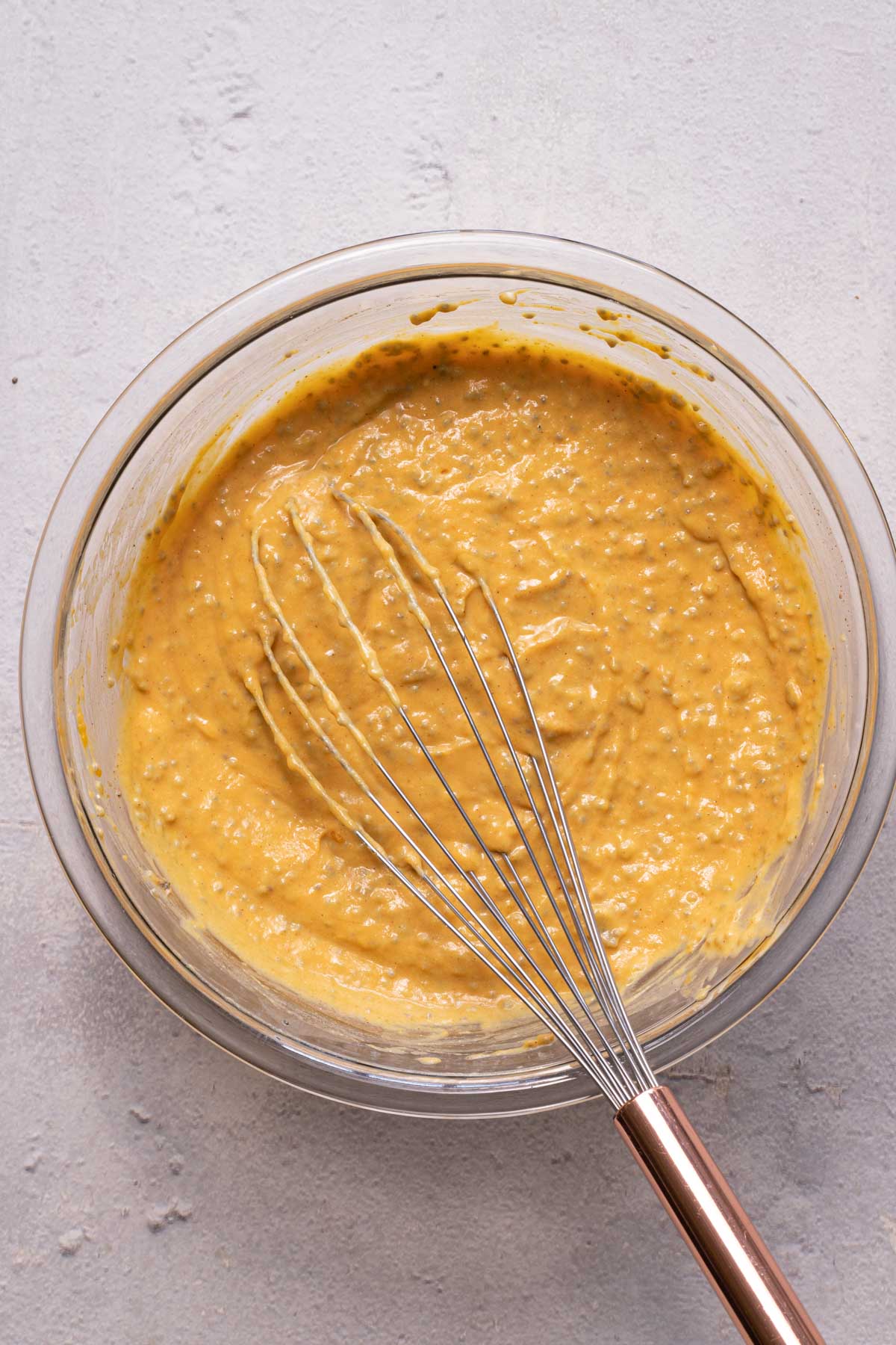 Pumpkin chia pudding with a whisk in a bowl