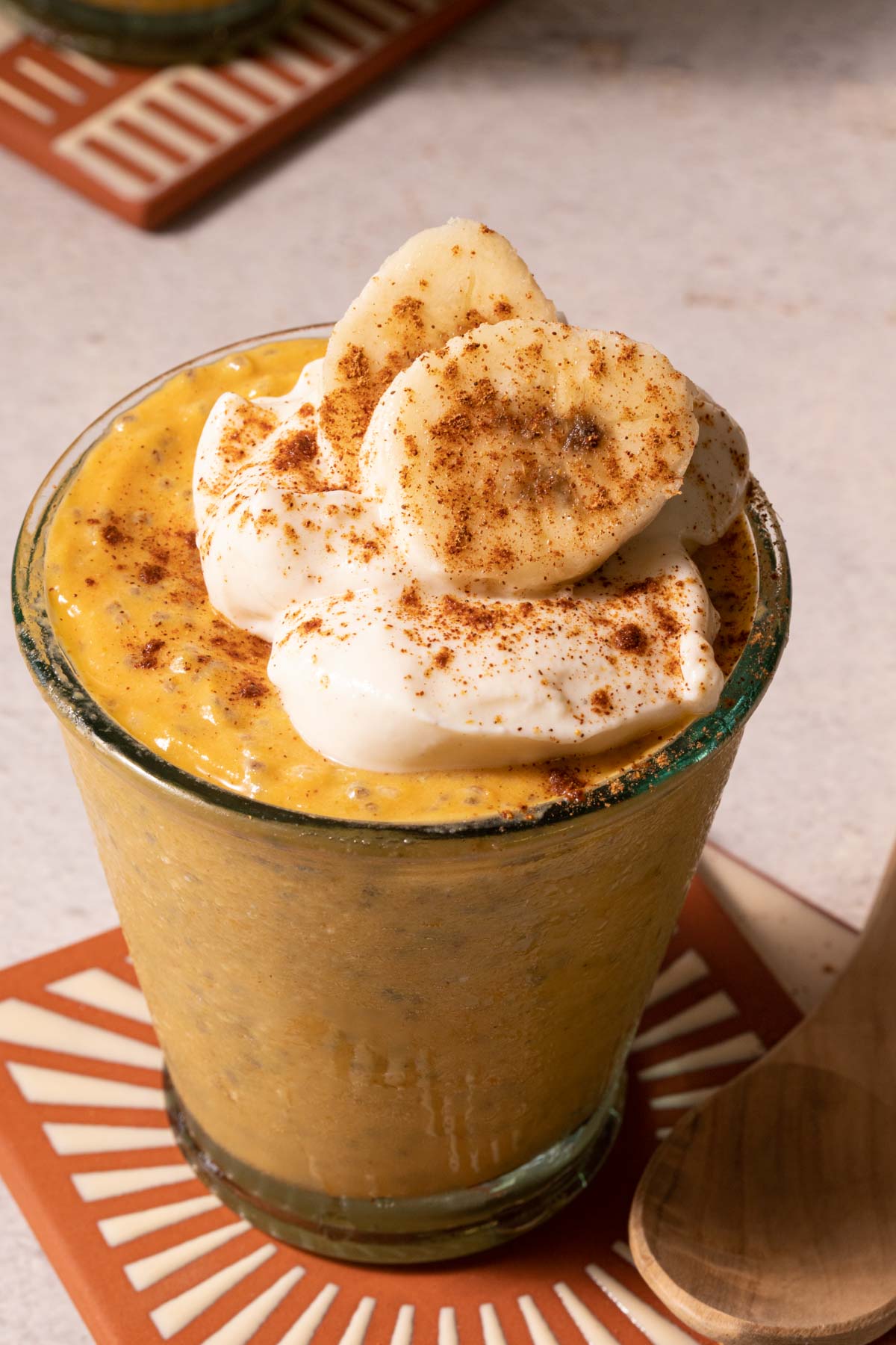 Pumpkin chia pudding in a glass with sliced bananas