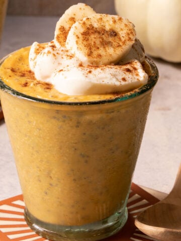 Pumpkin chia pudding in a glass with a spoon