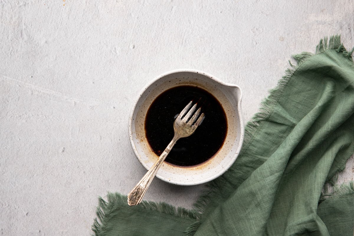 Balsamic vinegar and honey with a fork in a bowl