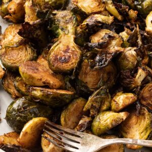 Crispy baked Brussel sprouts up close with a fork