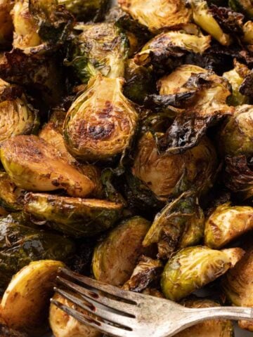 Crispy baked Brussel sprouts up close with a fork