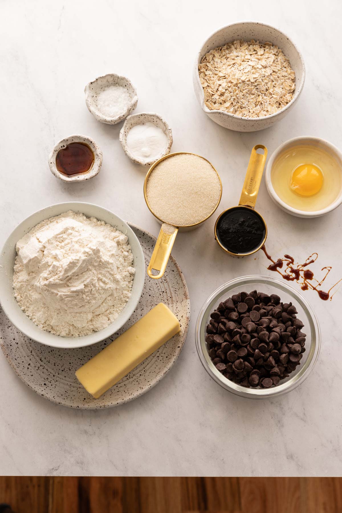 Bowls of ingredients for oatmeal molasses chocolate chip cookies