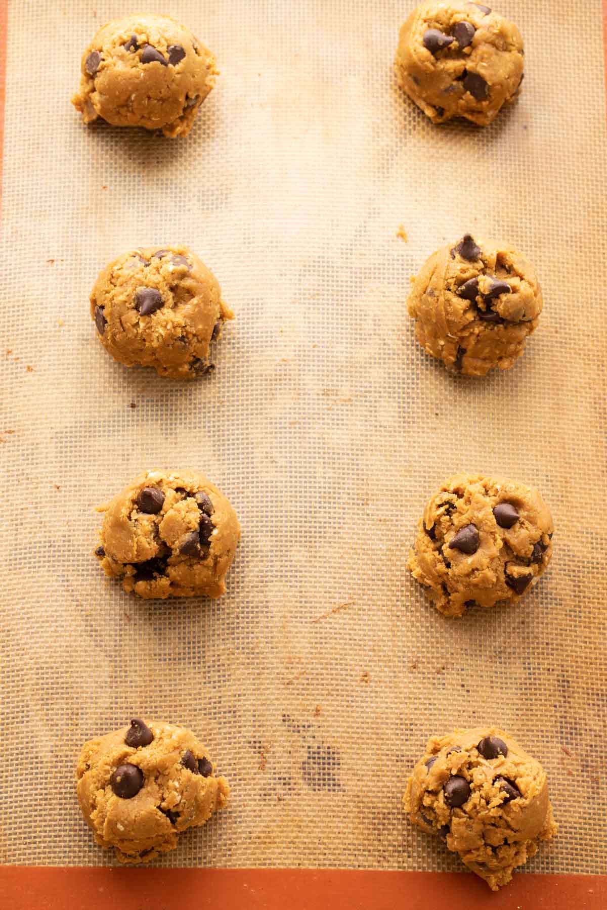 Oatmeal molasses chocolate chip cookies scooped on a baking sheet