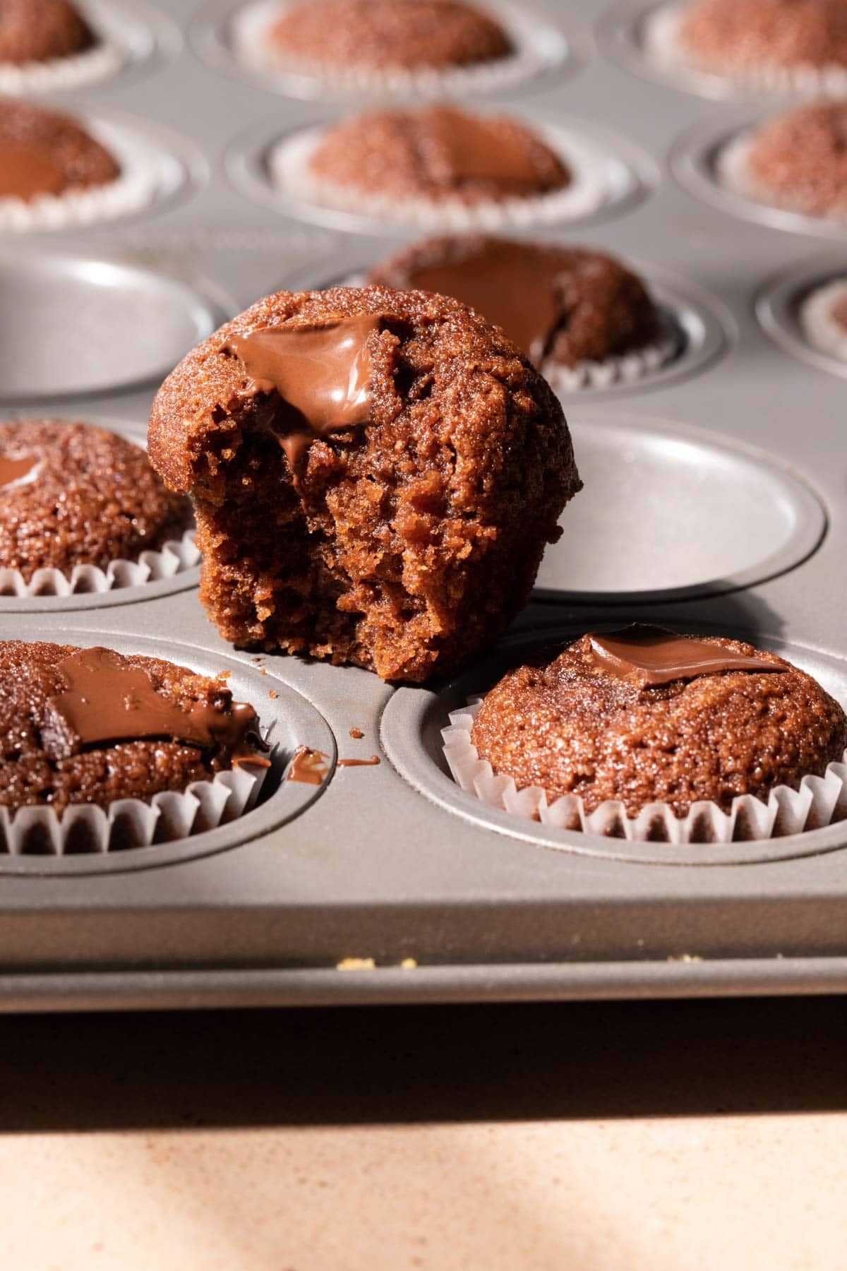 A bite take out of a chocolate financier