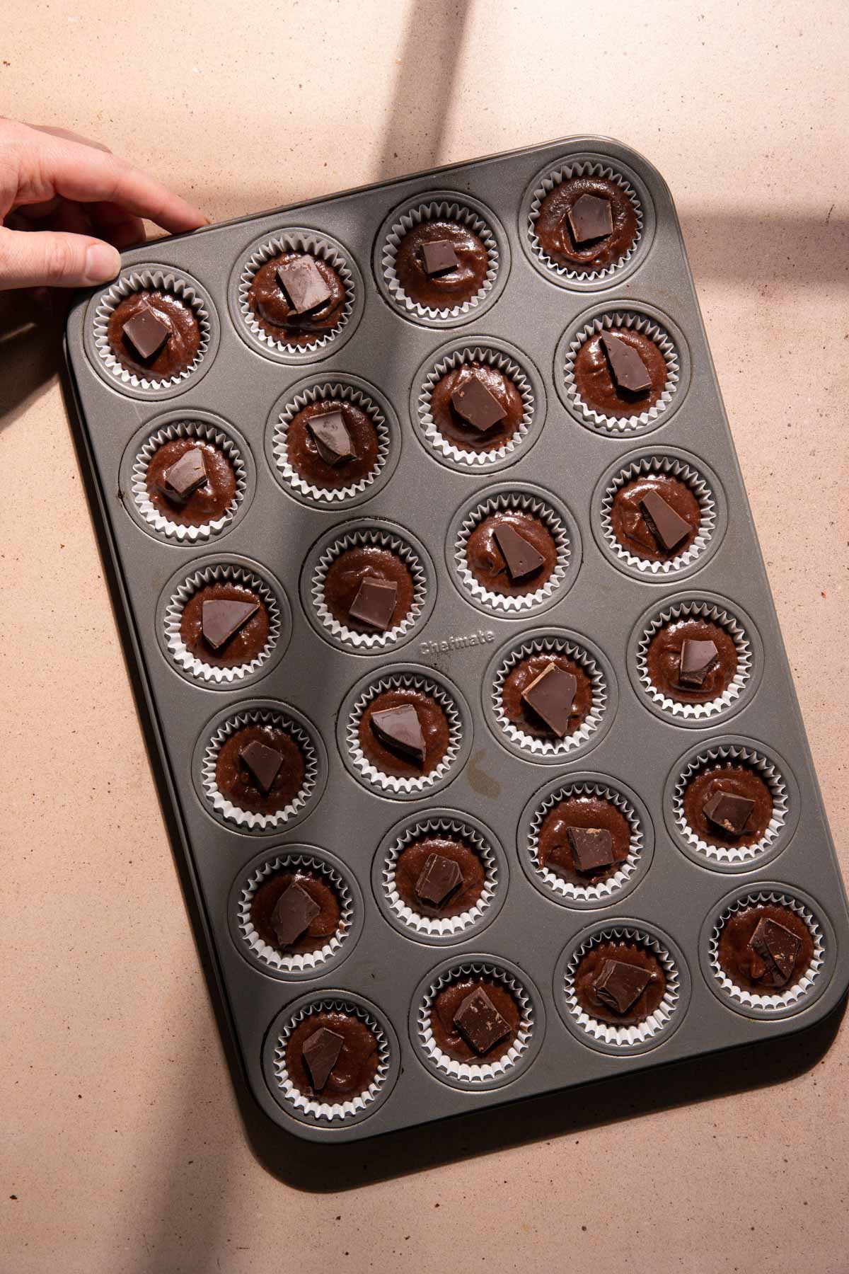 chocolate financiers scooped in a cupcake pan
