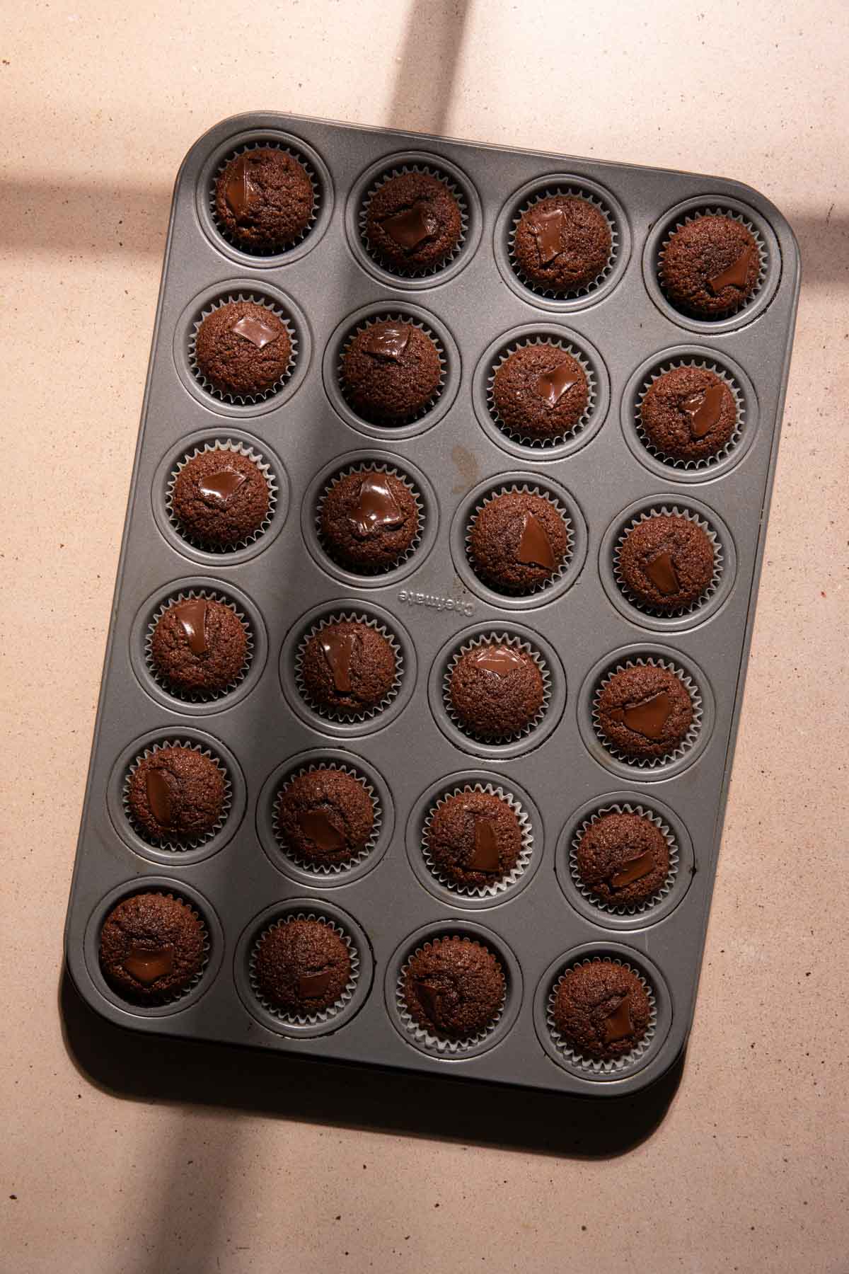 baked chocolate financiers in a cupcake pan