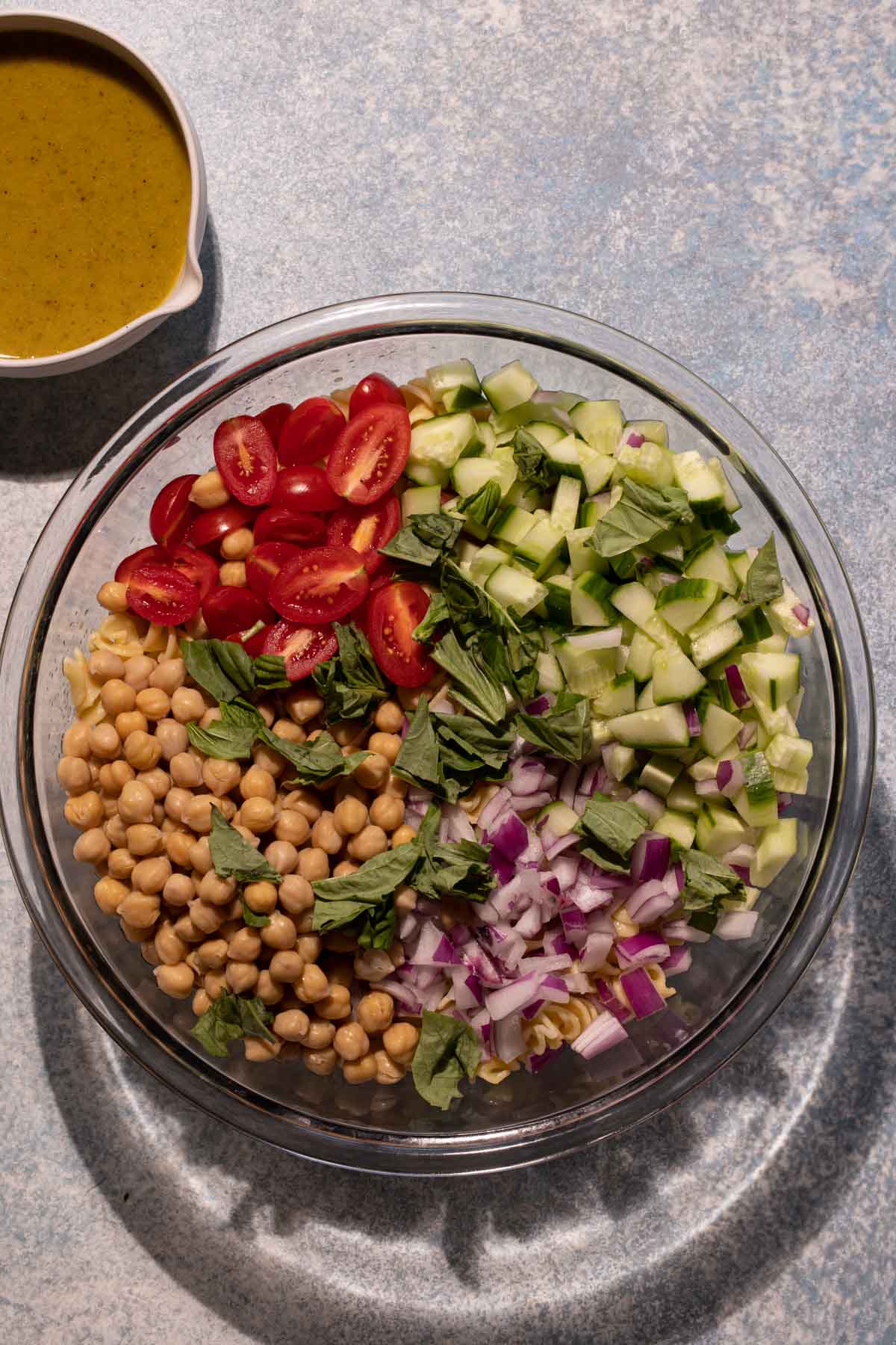 Chickpea Pasta Salad ingredients in a large glass bowl