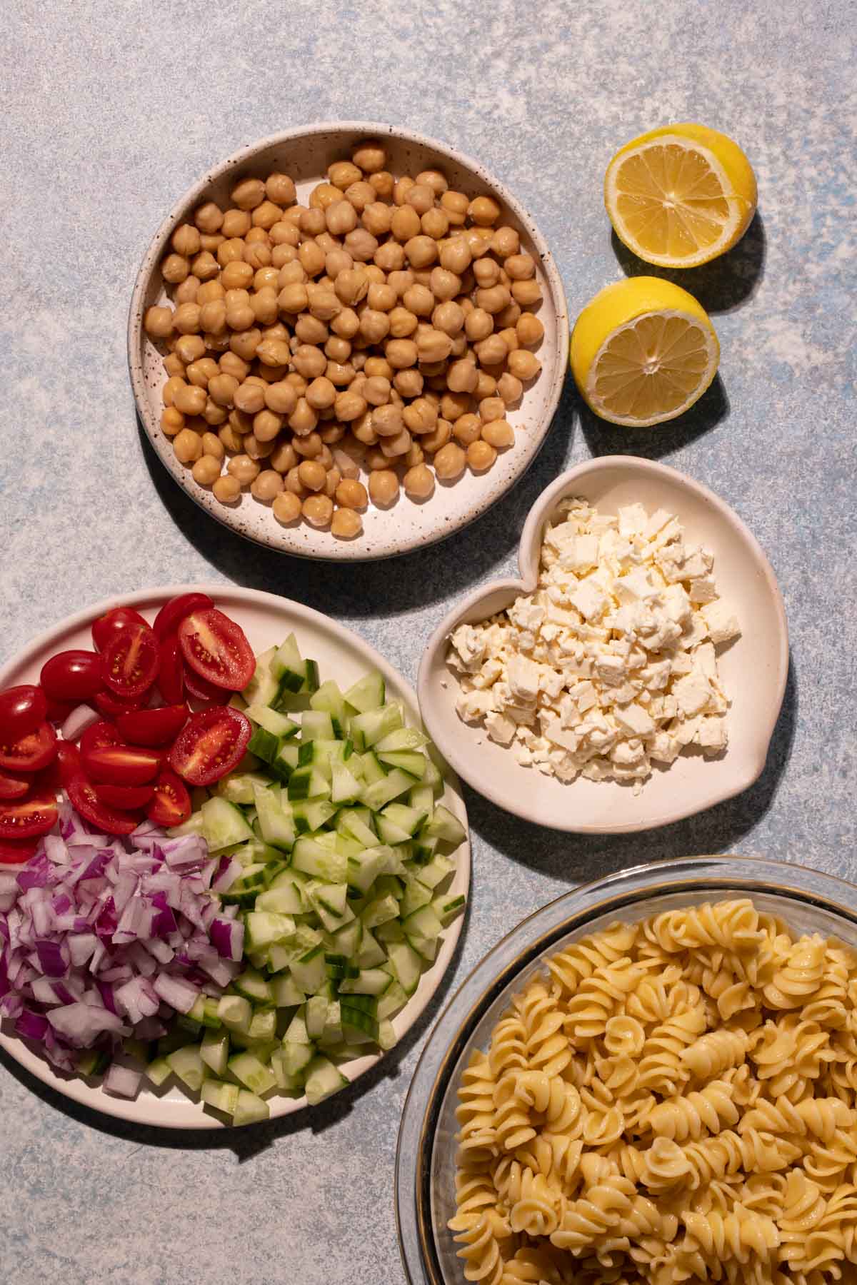 Chickpeas, feta, tomatoes, cucumbers, onions, and feta on plates