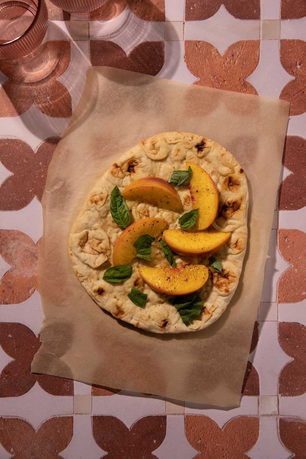 Peaches and fresh basil on naan bread