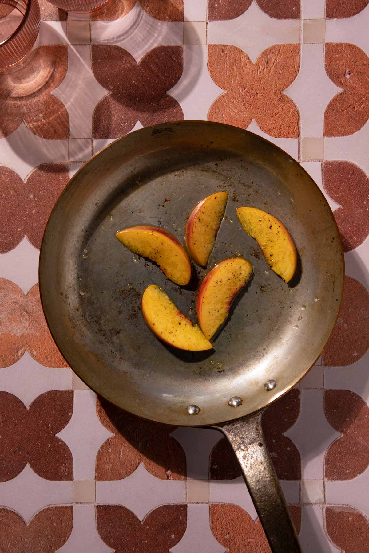 Peach slices in a saute pan