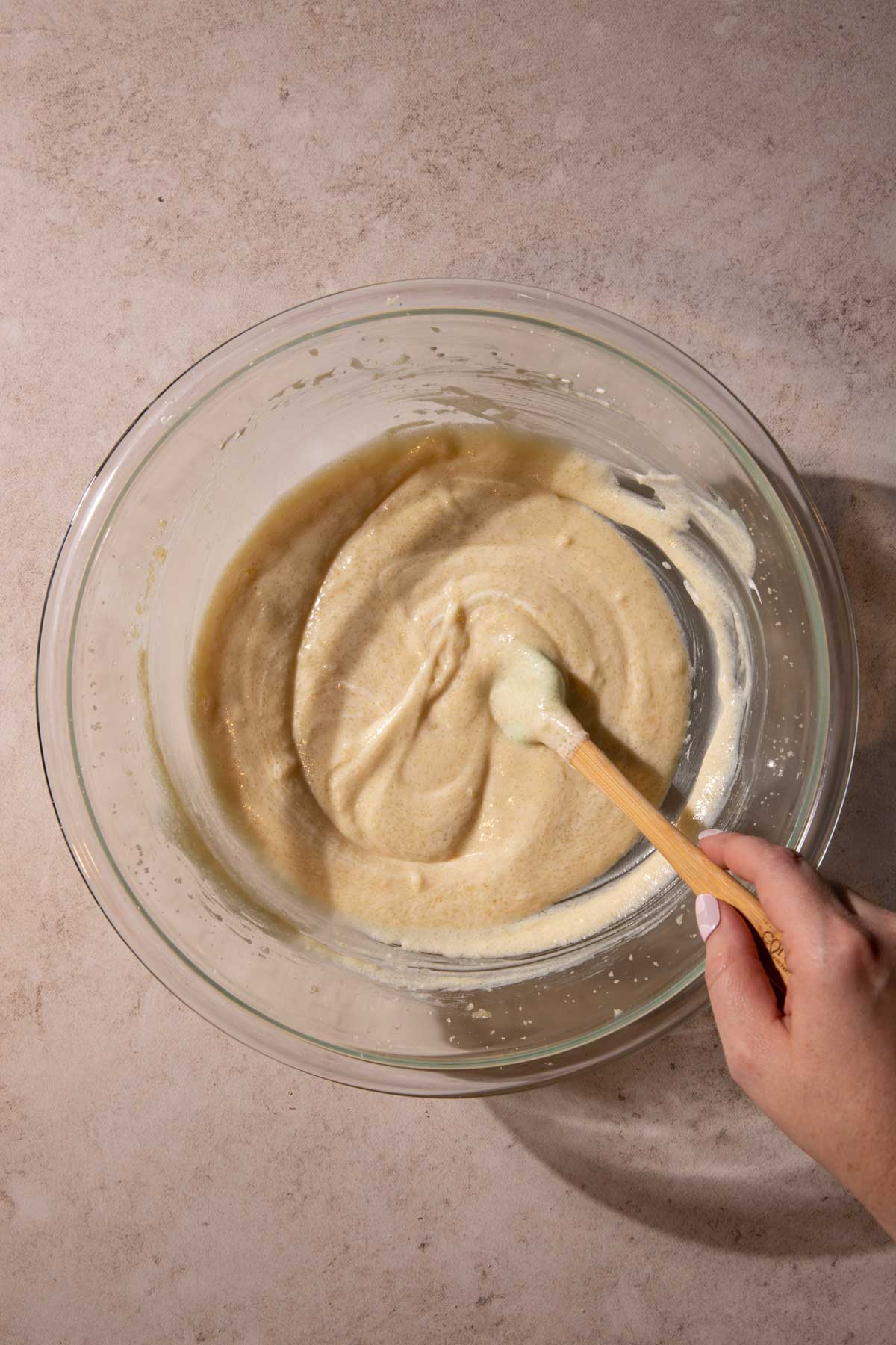 Apple streusel cake batter in a bowl with a spatula