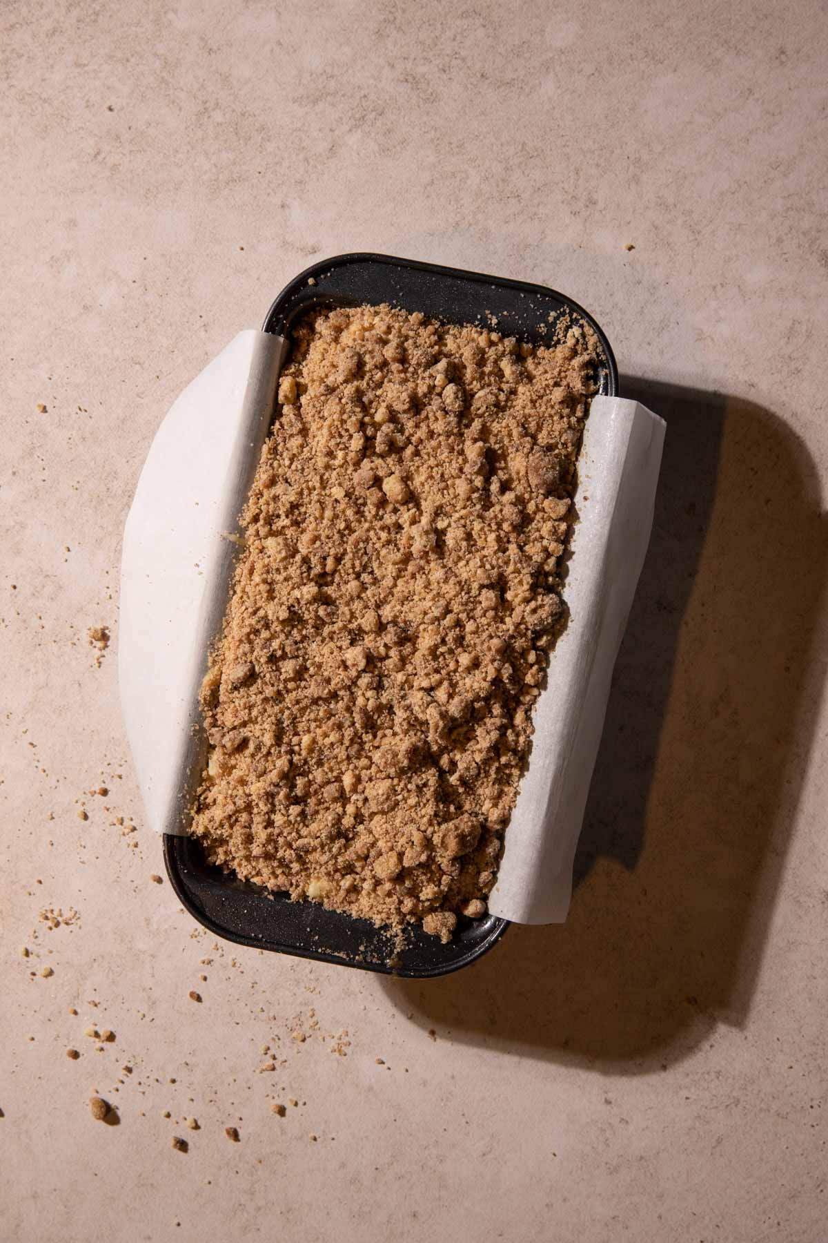 Apple streusel cake batter in a loaf pan