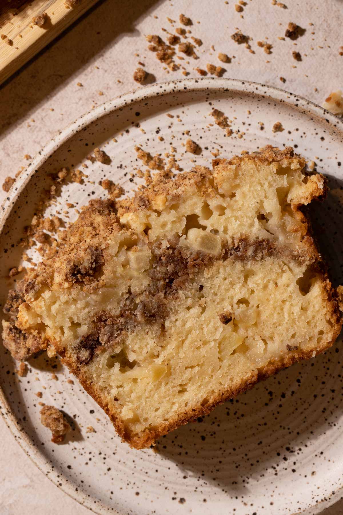 A slice of apple streusel cake on a plate