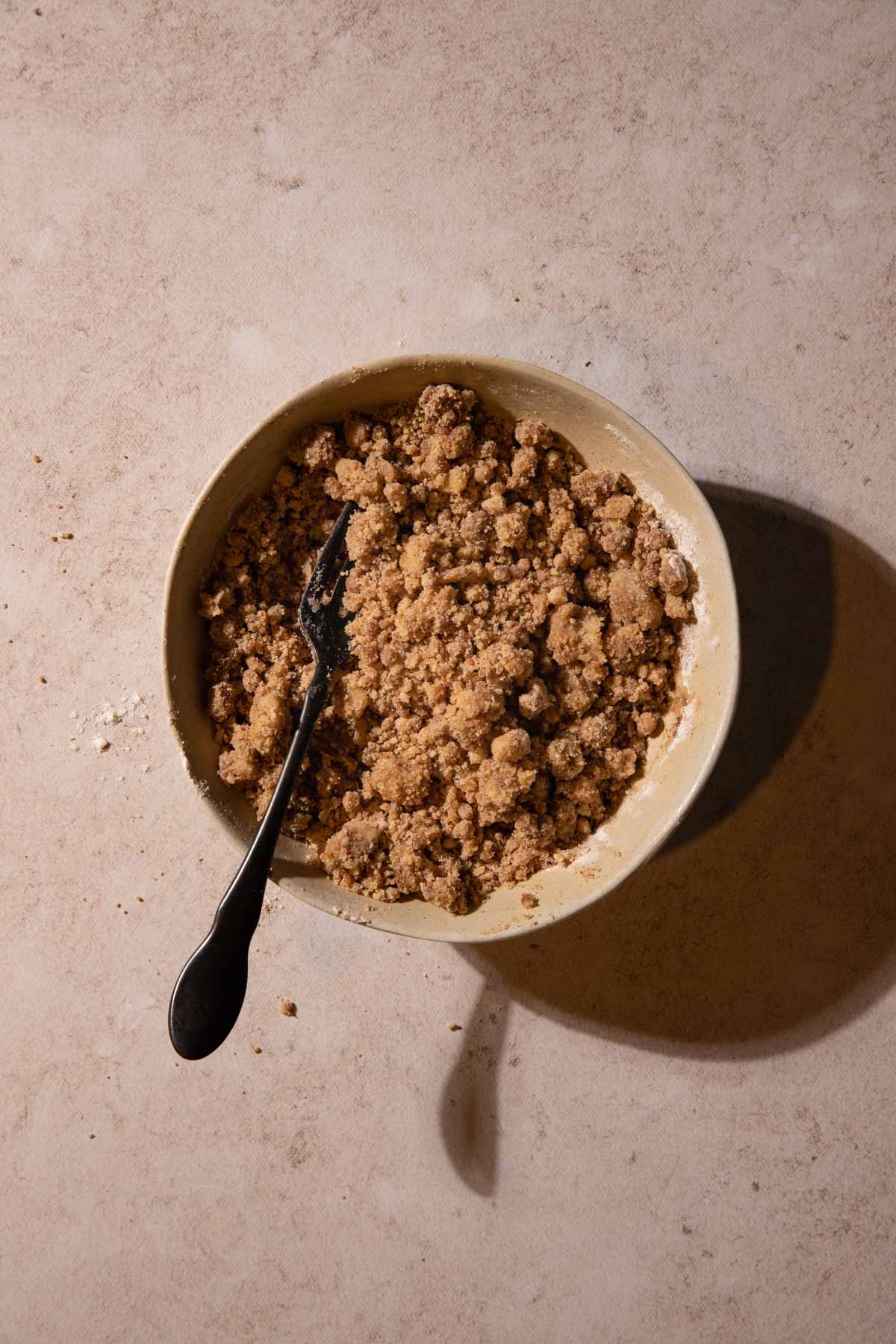 Streusel mixture in a bowl with a fork